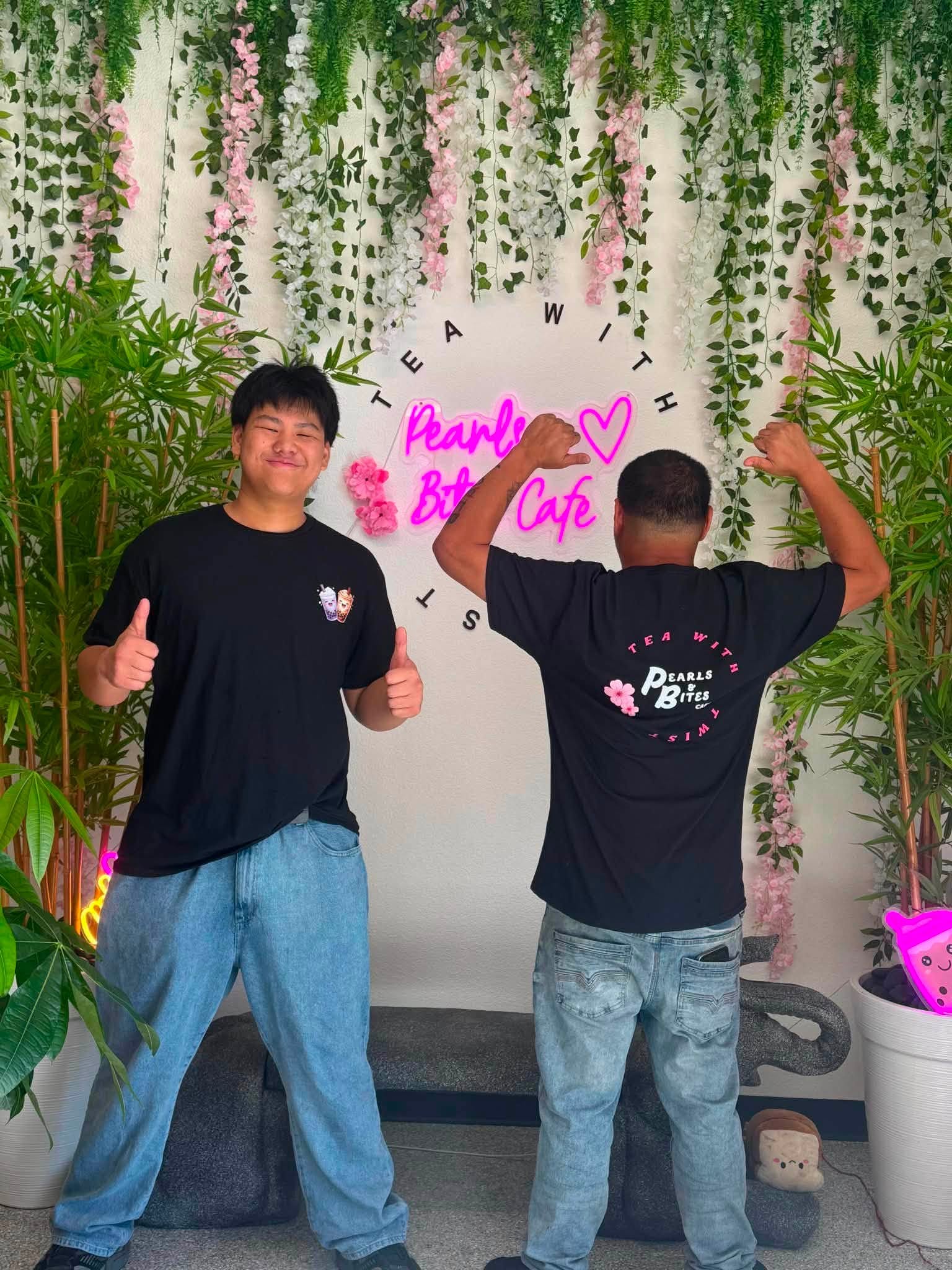Pearls and Bites staff showing front and back custom shirt designs